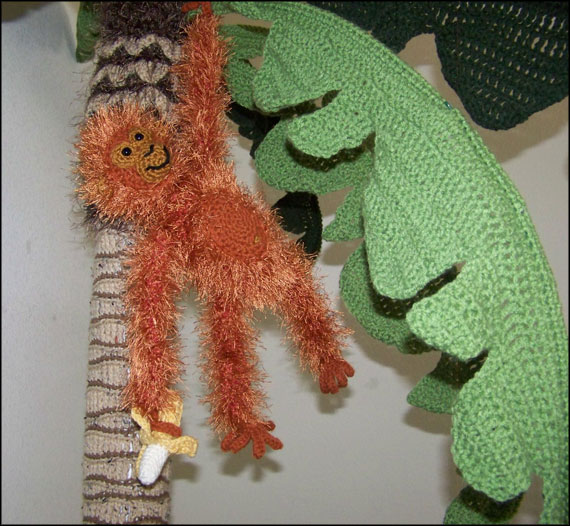 Monkey Hanging in Palm Tree with Banana