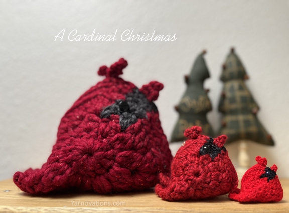 3 Cardinals crocheted in different size yarns from the crochet pattern "Birds of a Feather"